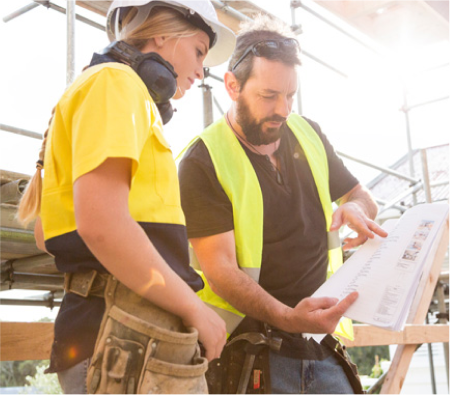 construction workers looking at a document.