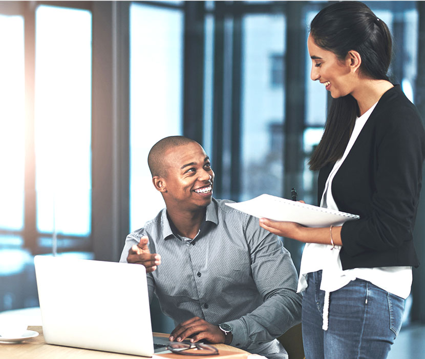 An asian male shaking hands with a female in the office