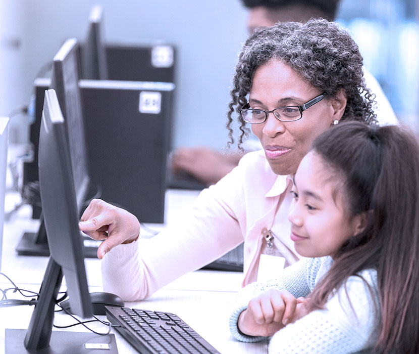 A tutor helping a student on the computer