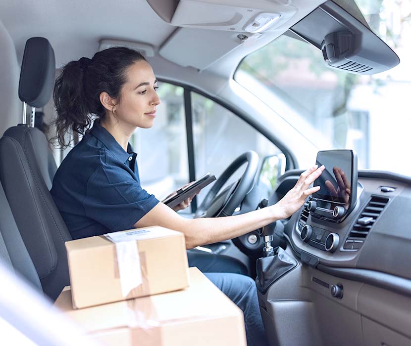 A female driver delivering packages.