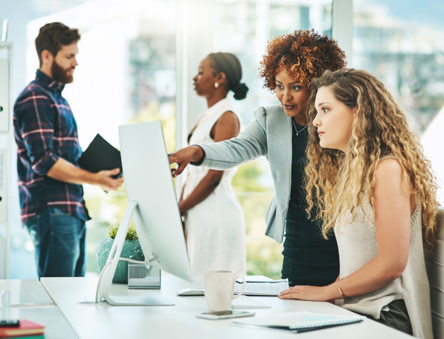 Female coworkers discussing at work