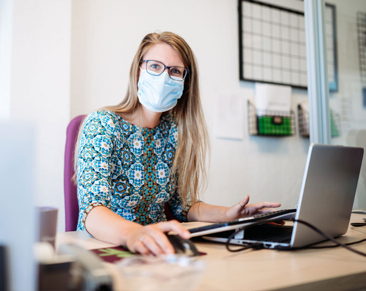 Woman working wearing a mask