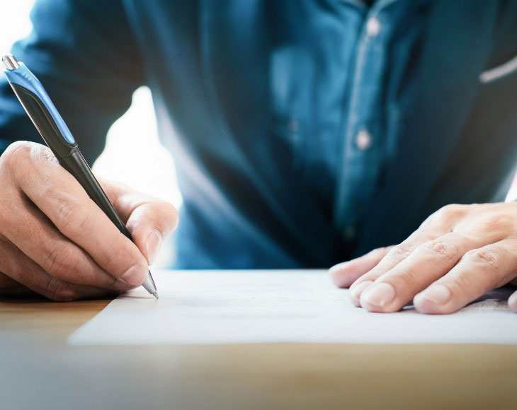 Close up businessman signing contract making a deal