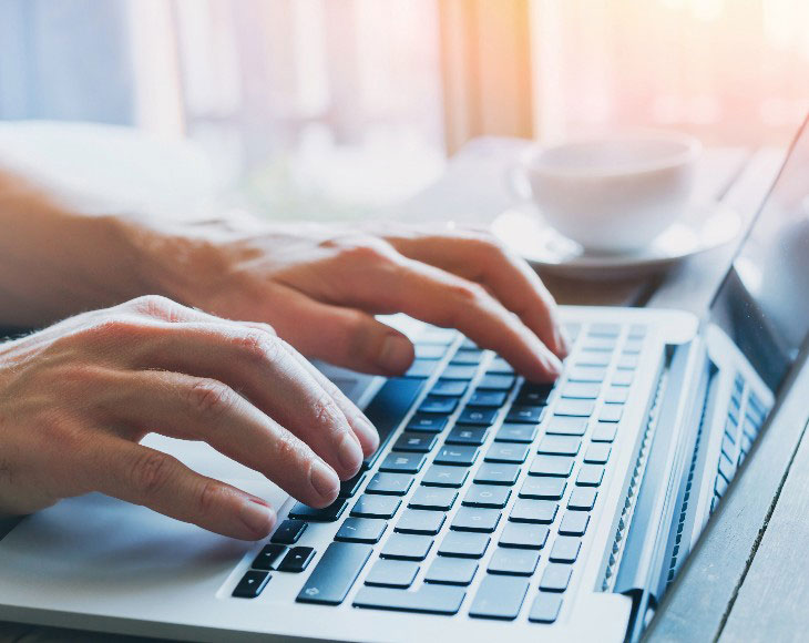 hands of business person working on computer