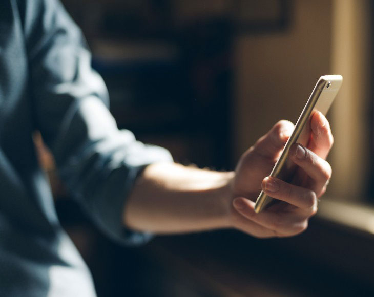 Young hipster using a mobile phone