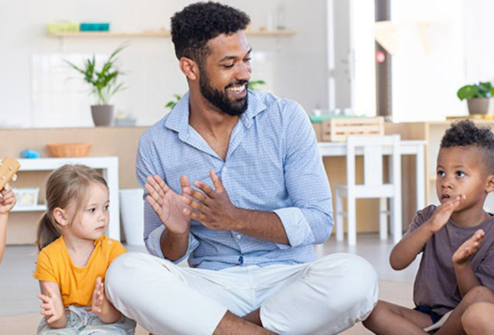 A Black male singing alone in a daycare