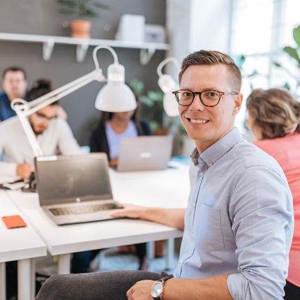A male smiling at a workplace